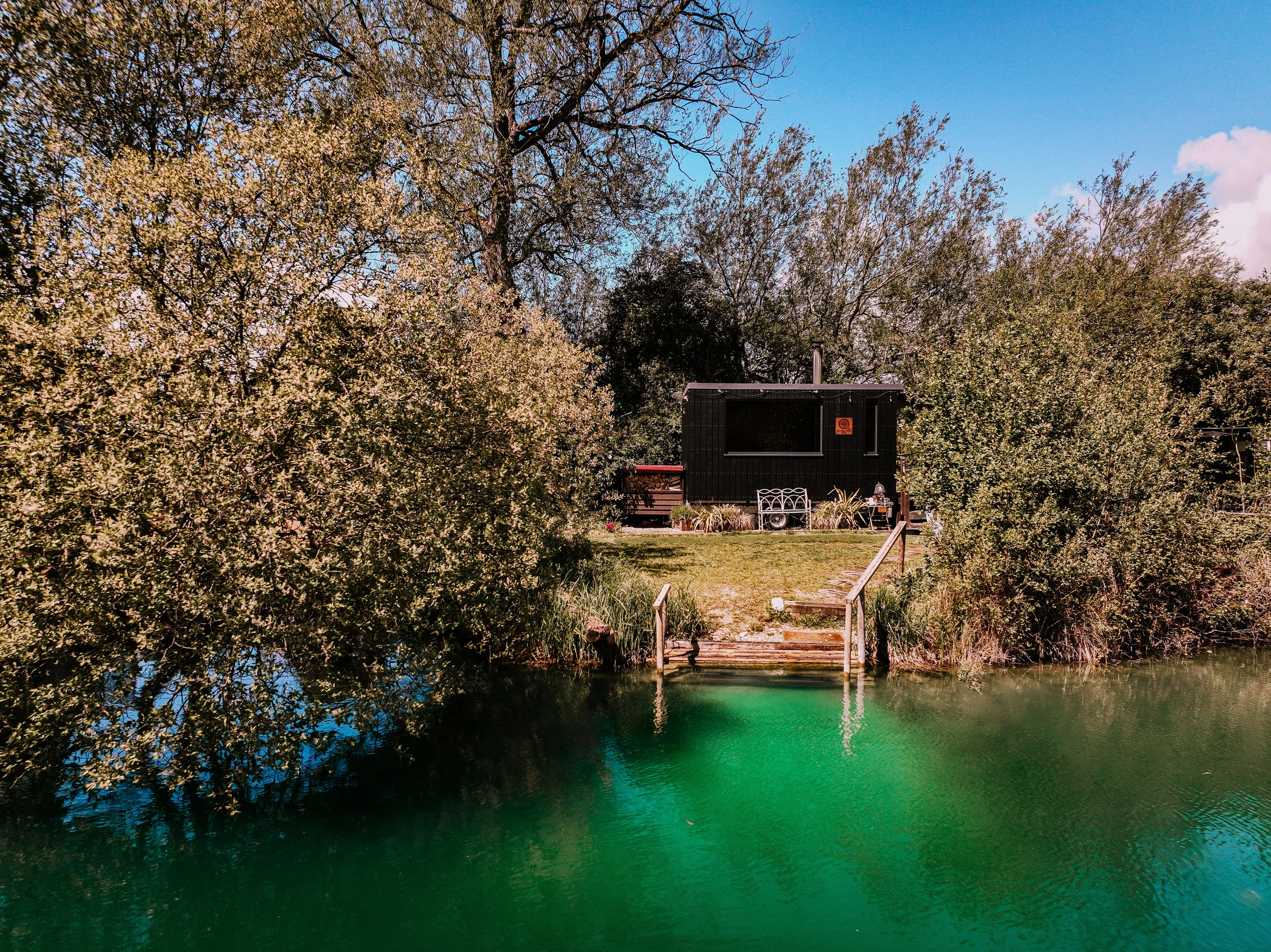 The Fallen Willow sauna above its jetty on the spring-fed lake